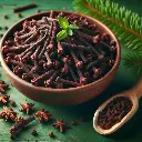 Cloves in a bowl with a few scattered, Freshlink watermark, green background. (2).webp