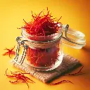 Saffron strands in a small glass jar, Freshlink watermark, yellow background (1).webp